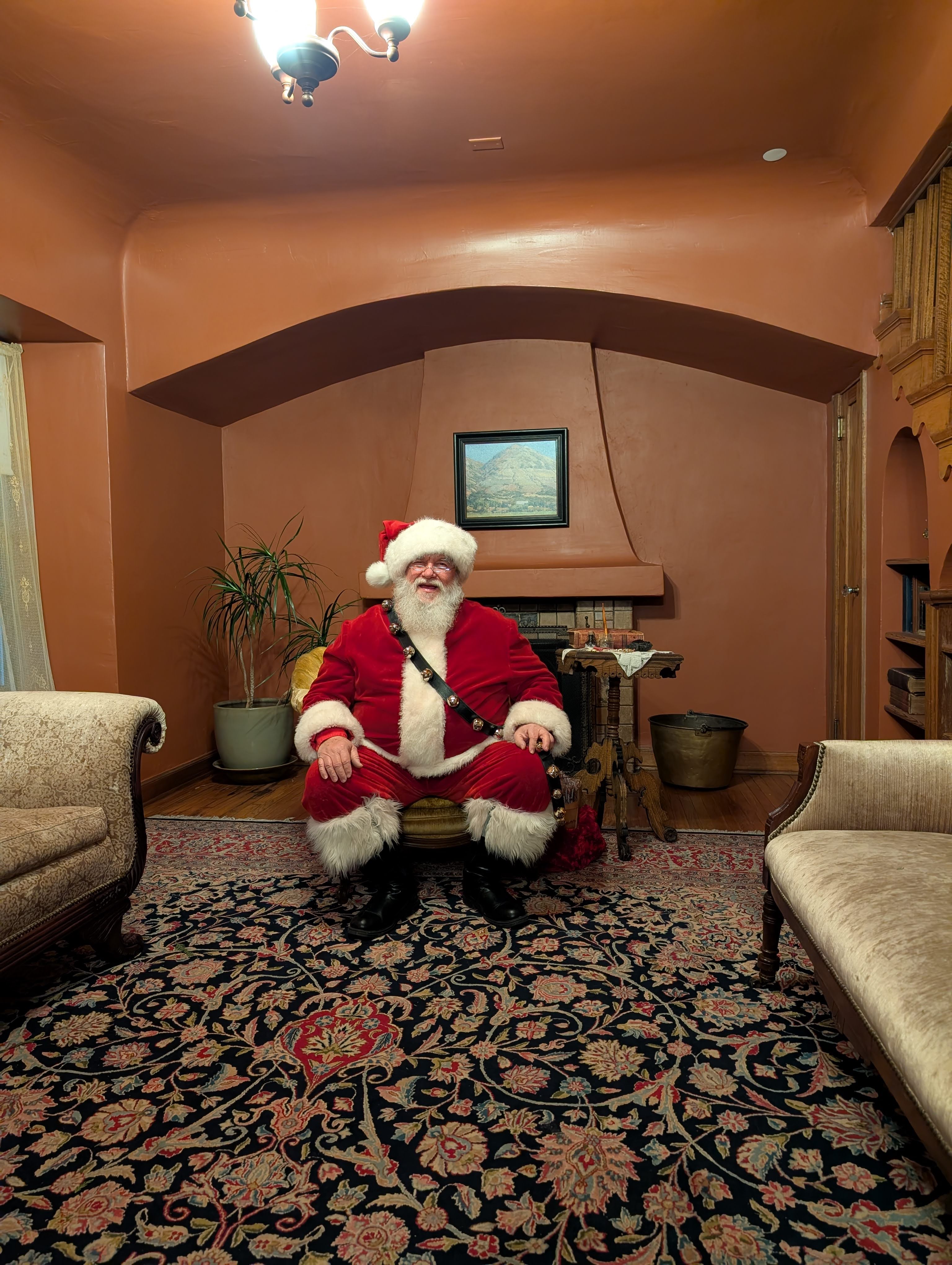 Santa Clause waiting for visitors in the main living room at the Whitaker Museum